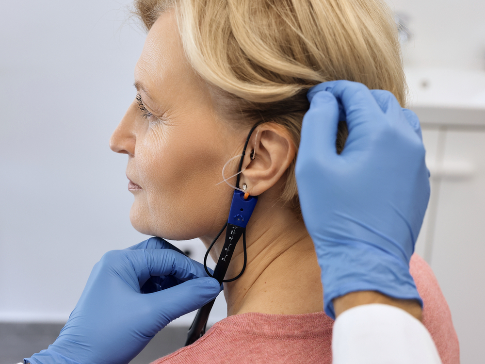 Audiologist performing real-ear measurement verification at Allen Audiology